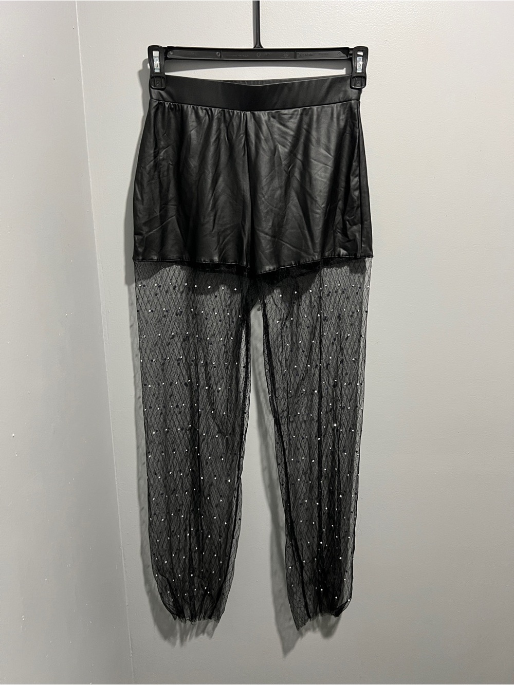 Y2K-inspired faux leather shorts with embellished sheer mesh wide-leg pants